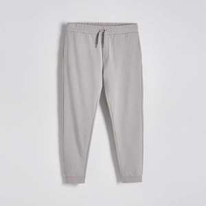 Reserved - Dámské sportovní kalhoty s proužkovaným patentem - Světle šedá obraz