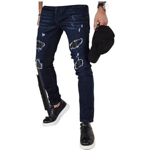 Tmavě modré džíny s oděrky obraz